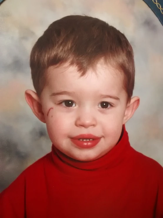 a close up of a child wearing red