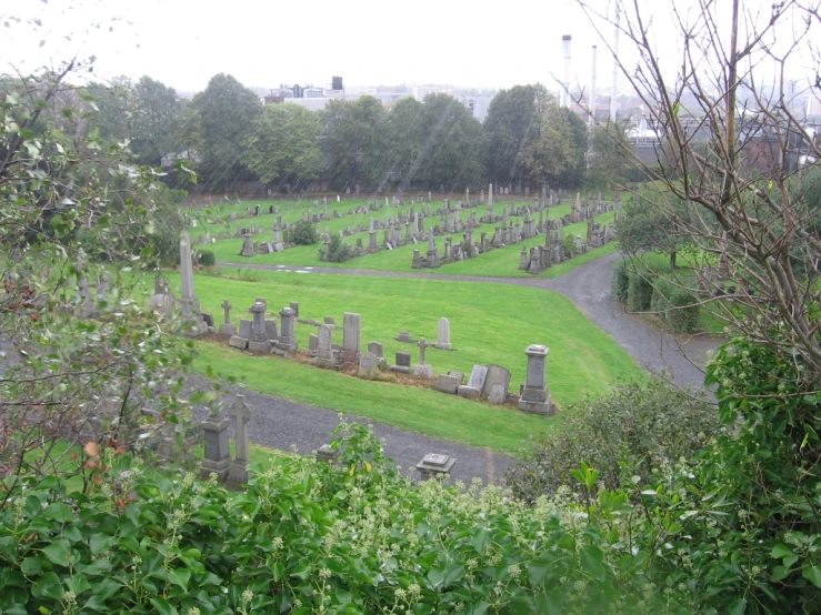 a cemetery with trees in the background