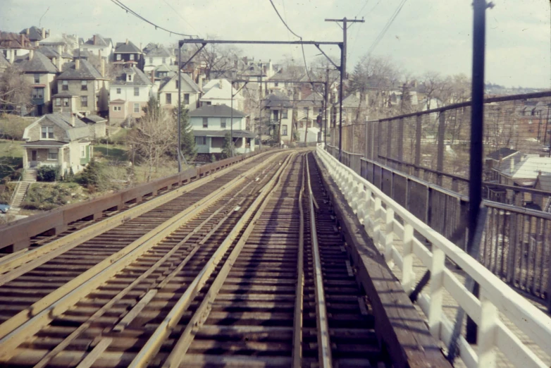 the train tracks lead up to the city