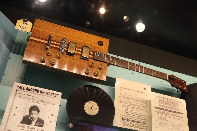 an old guitar is hanging up in the museum
