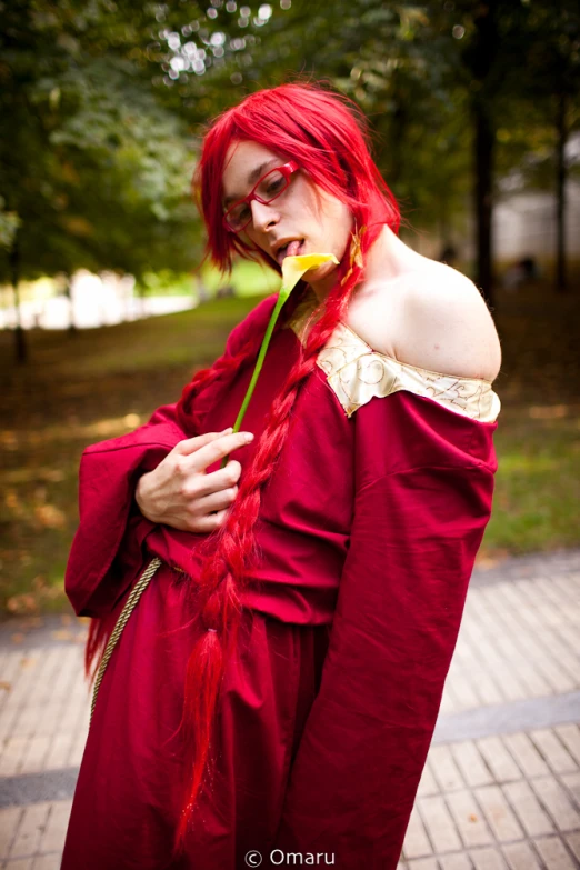 a woman with red hair and red makeup in a renaissance costume