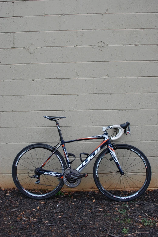 there is a bike leaning up against a brick wall