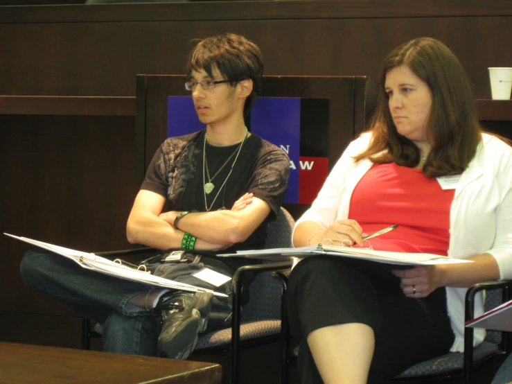 people sitting in chairs looking at the camera