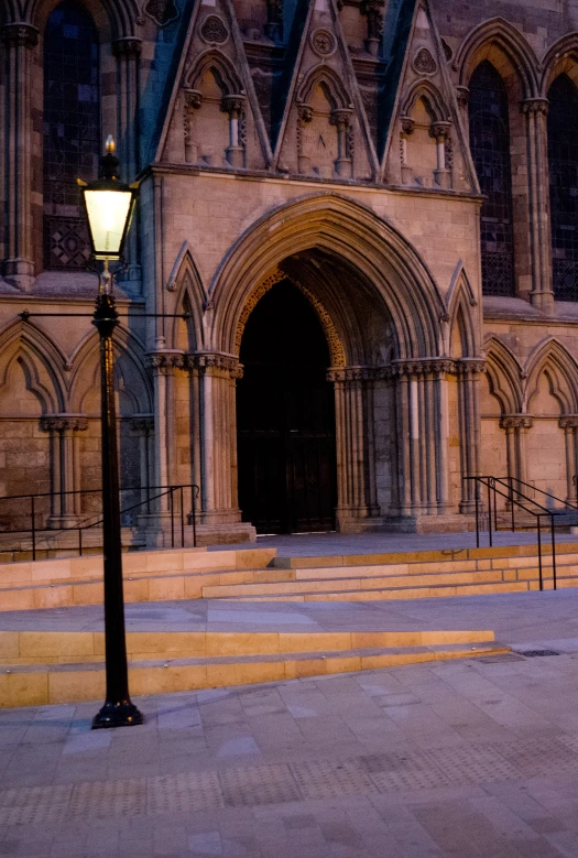 the light shines on the steps leading to a big building