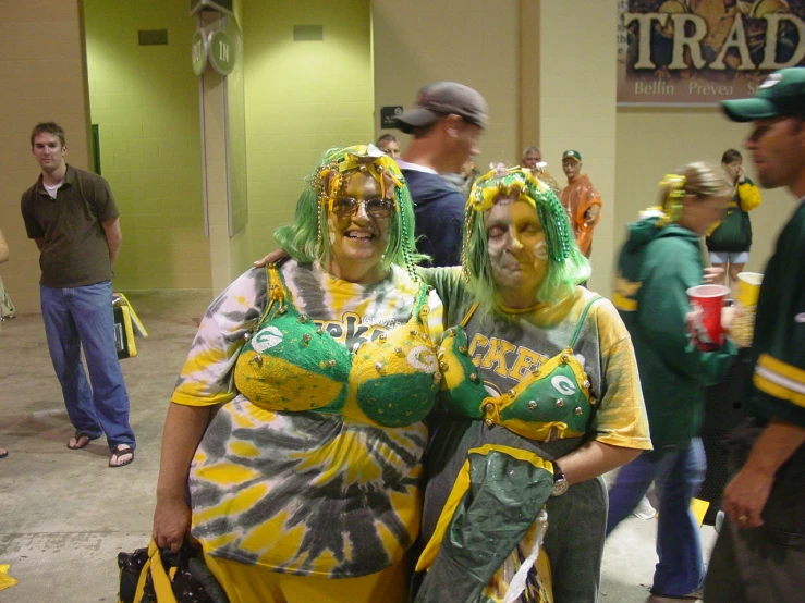 two people that are wearing costumes with some paint