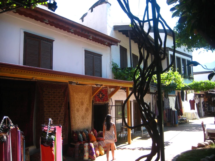 the back side of a house on an island with several pieces of furniture sitting outside