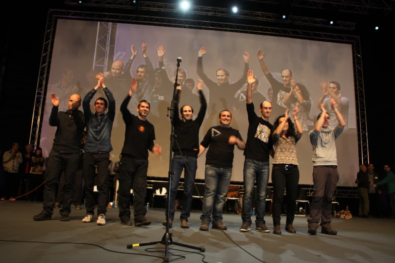 a group of people holding up their arms with each other