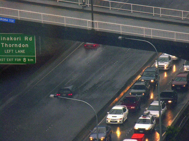 a highway filled with lots of traffic next to freeway signs