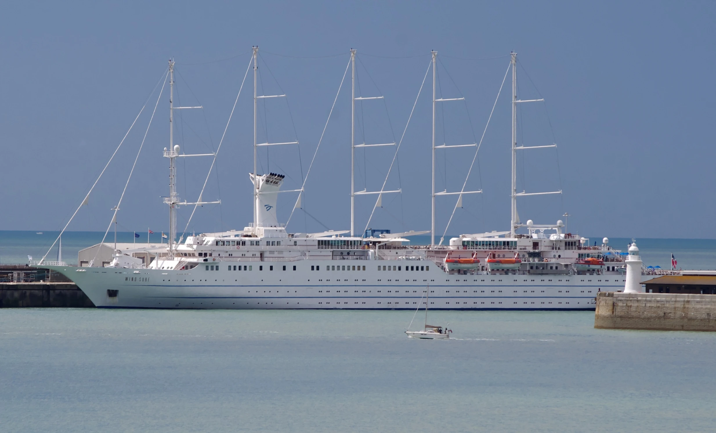 a large white ship sitting next to a pier