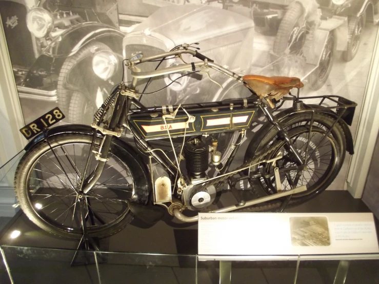 an antique motorcycle and helmet with a display case
