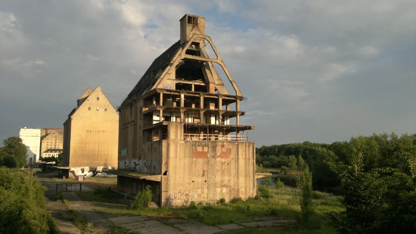 an old barn being constructed into soing next to a building