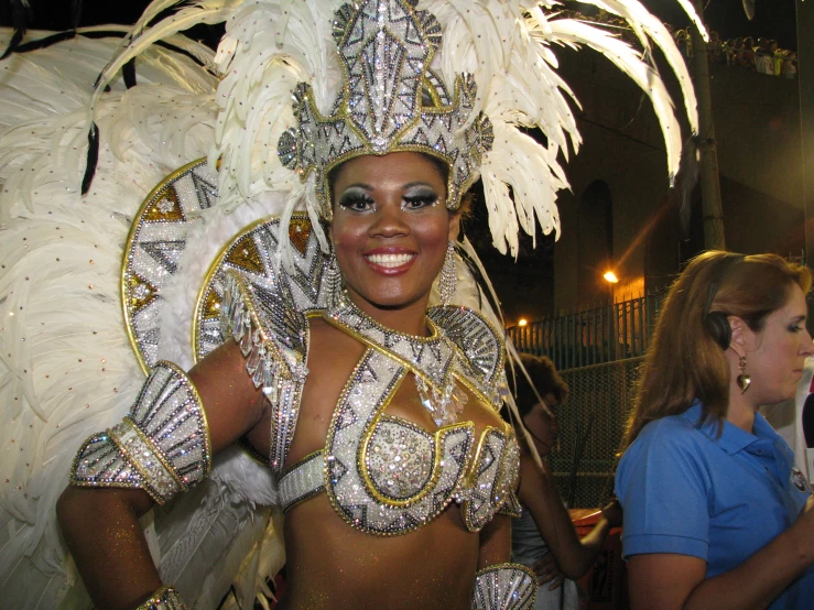 a woman in a parade outfit with feathers