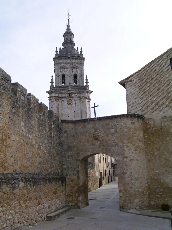 a view of an old stone church tower from the street