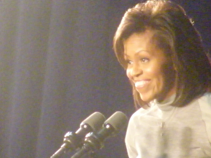 the african american woman is speaking at a podium