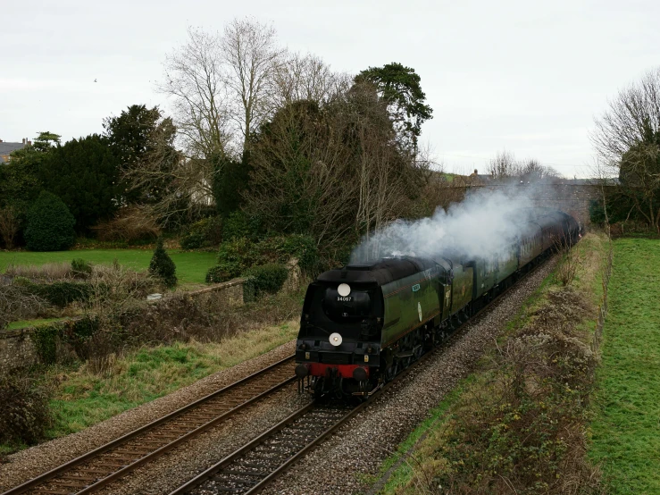 a train moving down the tracks through the countryside