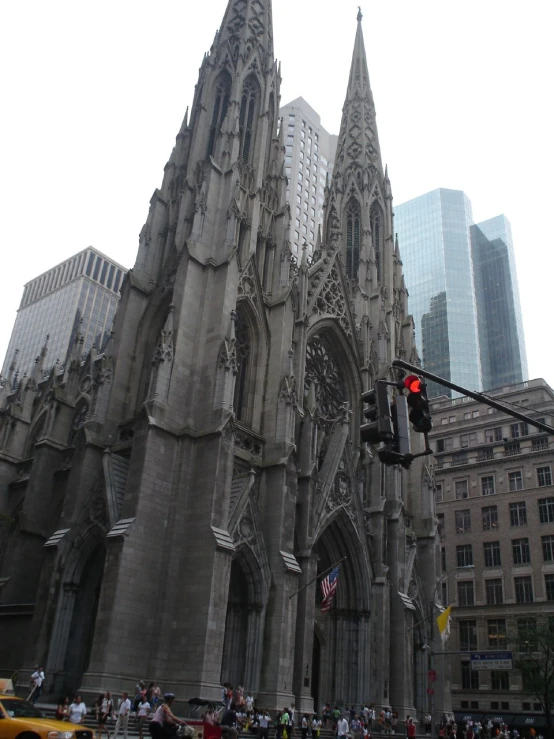 a very large cathedral building next to a traffic light