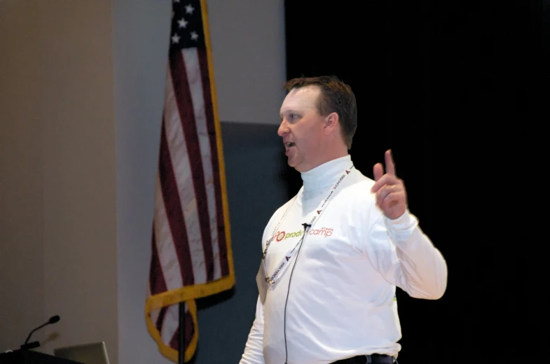a man in white shirt giving a presentation