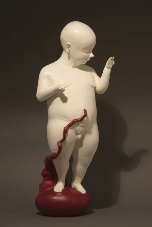 a white statue with a red object in it