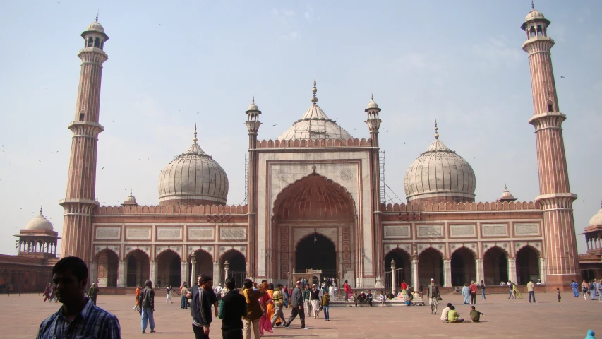 many people are standing outside of a building