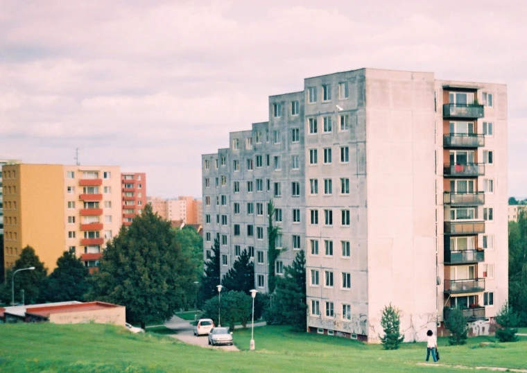 an apartment block stands alone in a city