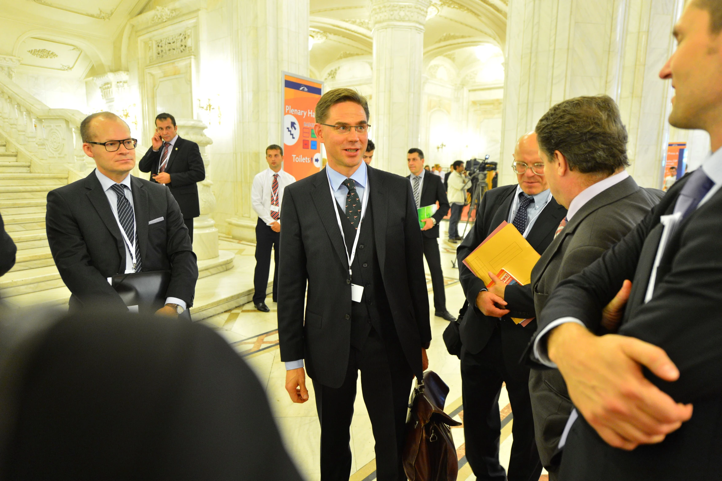 men in suits and ties stand next to each other