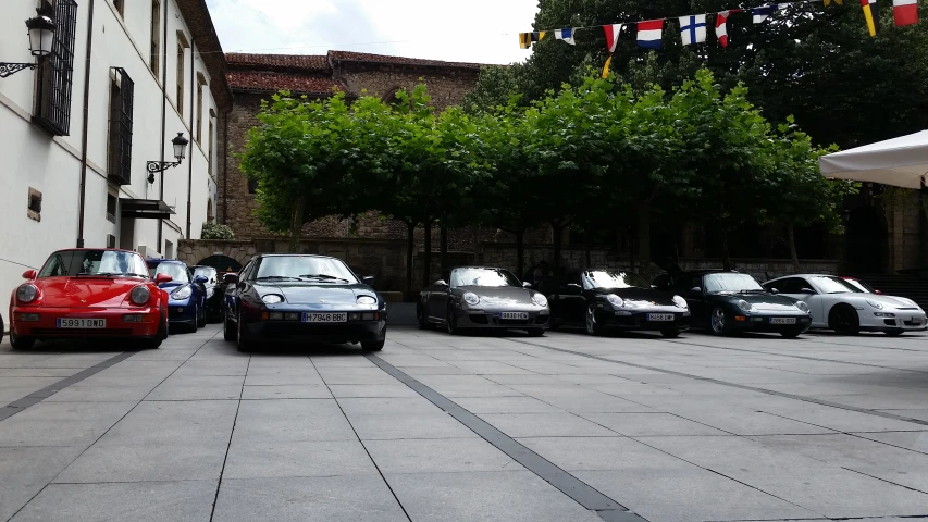 four black cars parked in front of a building