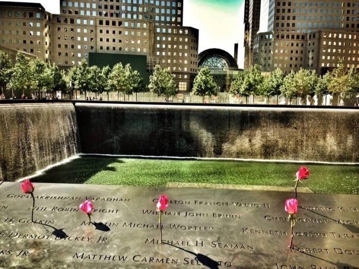 memorial with pink flowers in a city park