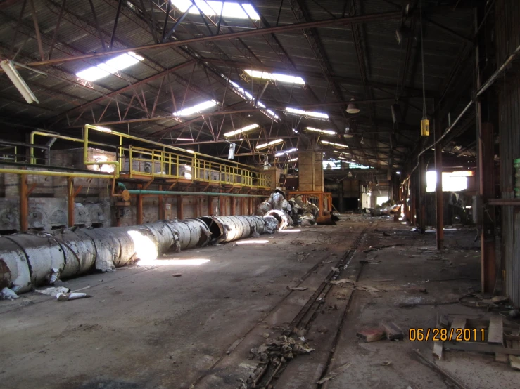 old, industrial metal building filled with steel pipes