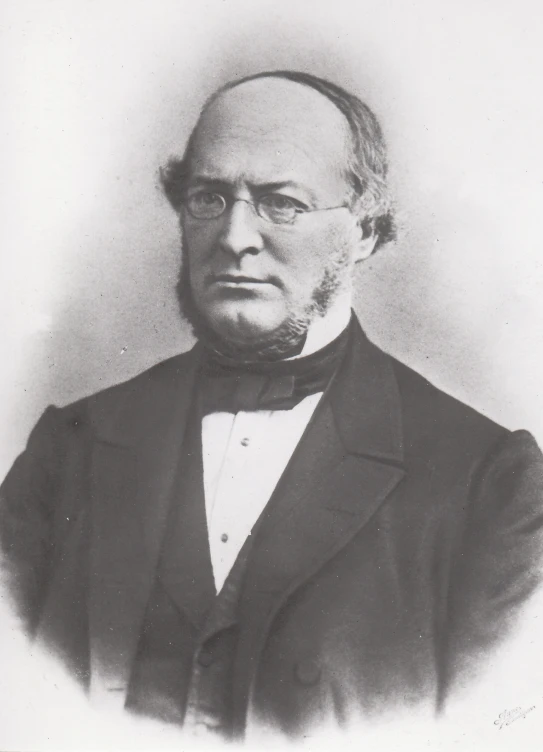 a portrait of a man in a suit with glasses