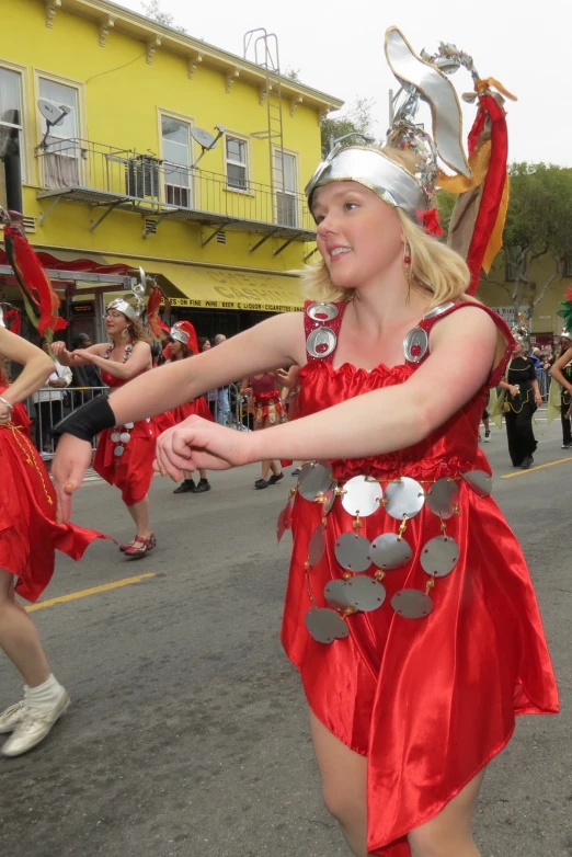 a girl dancing in an ornately decorated street