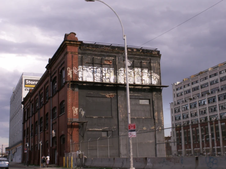 a tall building with graffiti on it near a city street