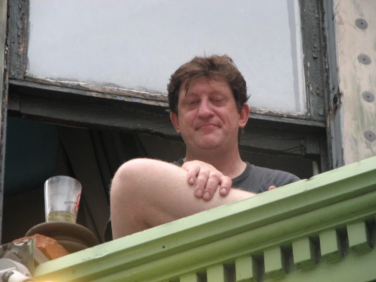 a man staring out from inside a building