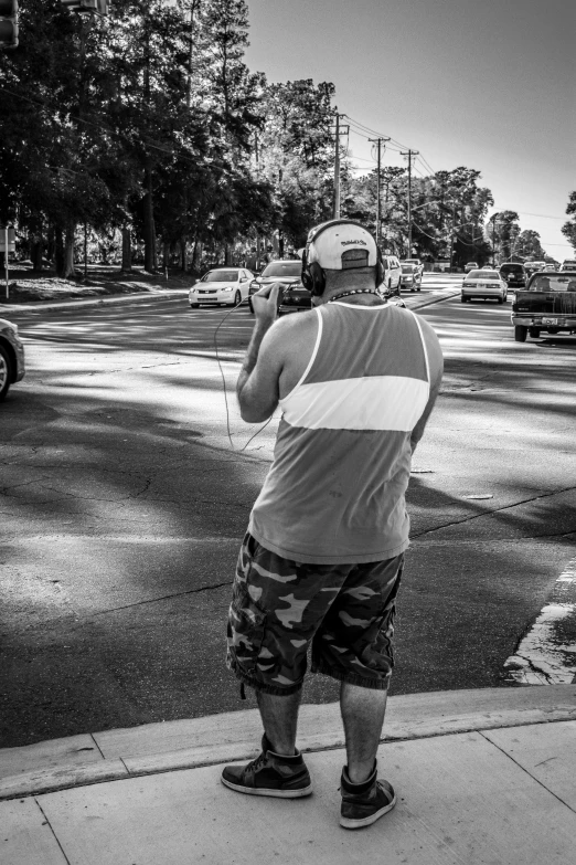 a man that is standing in the street with a camera