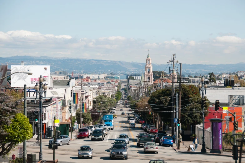 many cars are traveling down a busy street