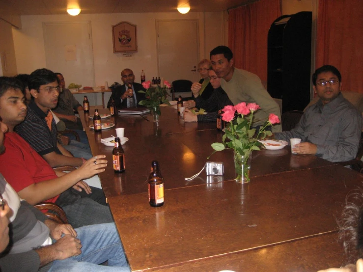 a group of people sitting around a table in front of drinks