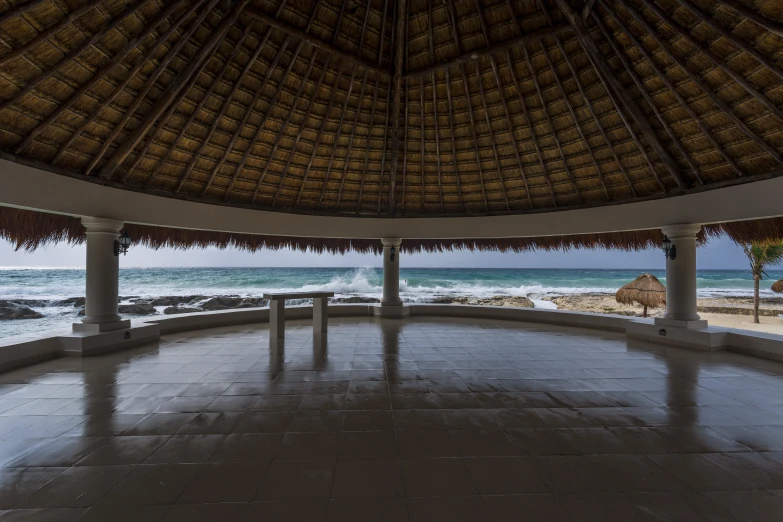 an empty and wide open air pavilion with two benches