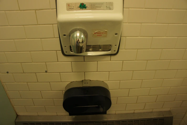 a white brick wall mounted urinal in a restroom
