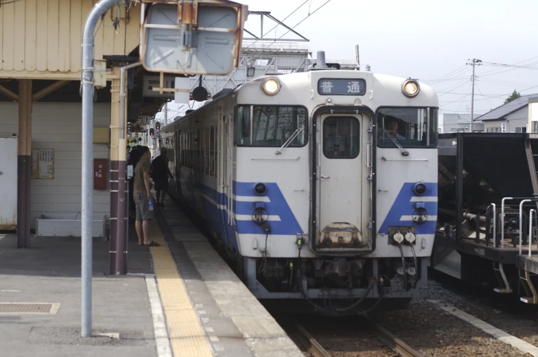 a passenger train on the tracks that is being pulled up to the station