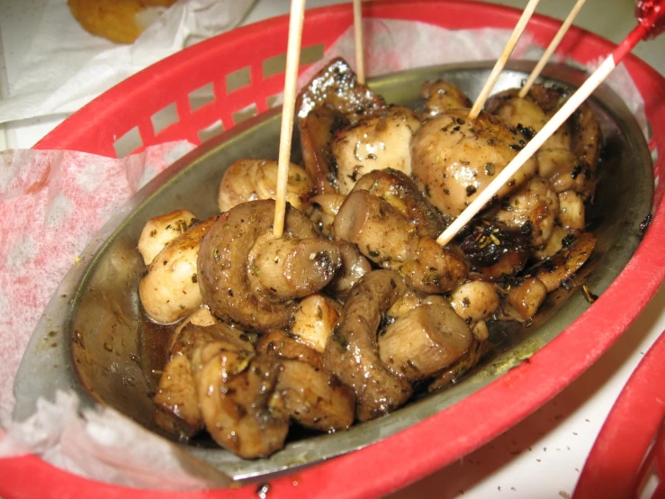 cooked chicken and mushrooms on a spoon in a bowl