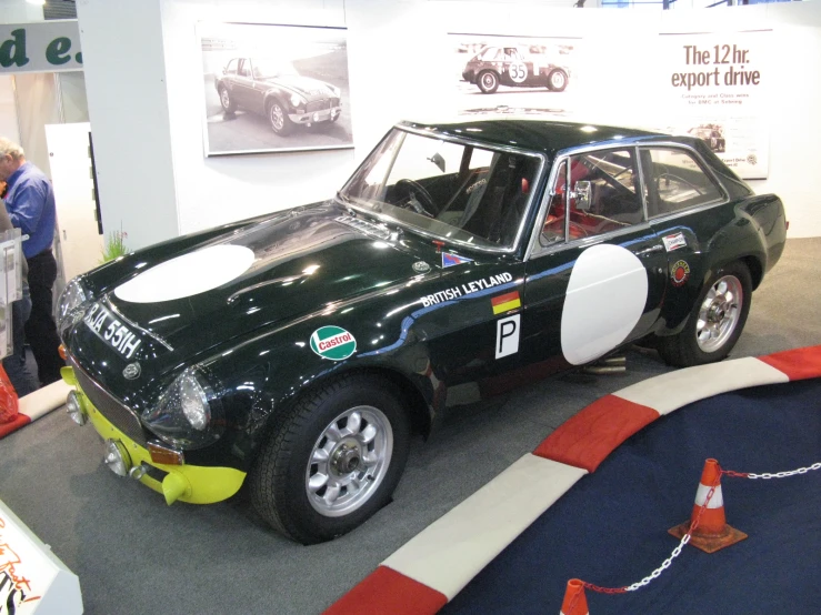 a green and white race car on display