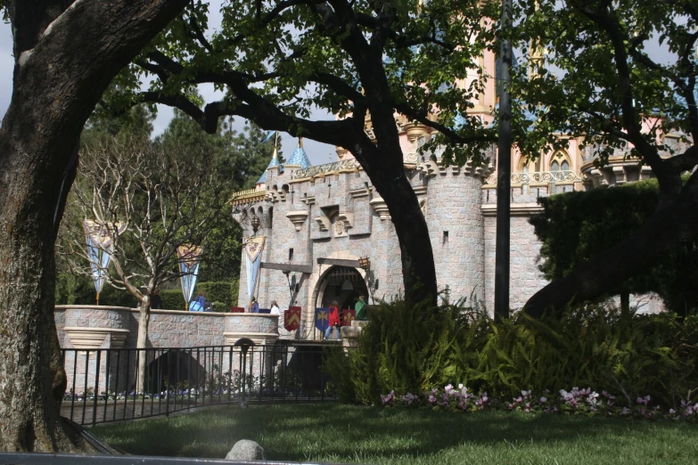 a group of trees near a large stone castle