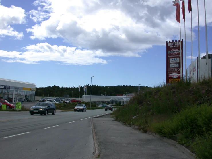 cars drive down a street near an old motel