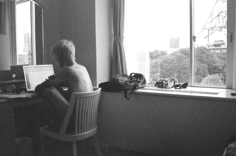 a person sitting at a table looking out the window