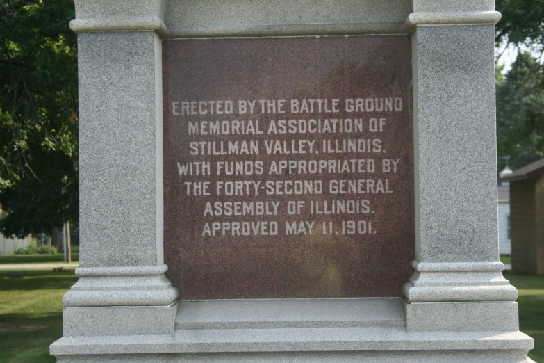 a monument in a park with a picture etched into the stone