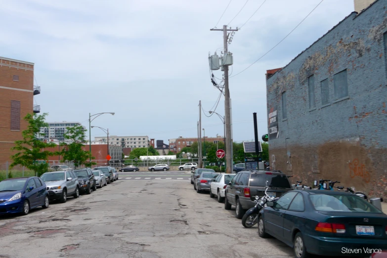 a street filled with cars next to a brick building