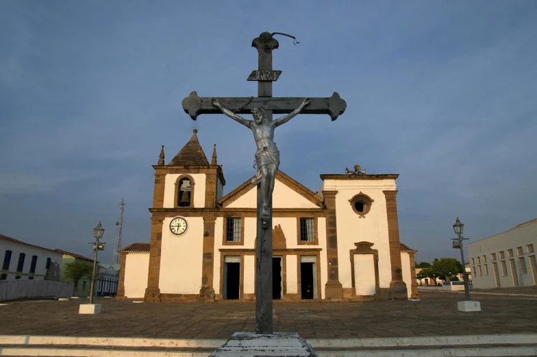 an old church with a cross in front