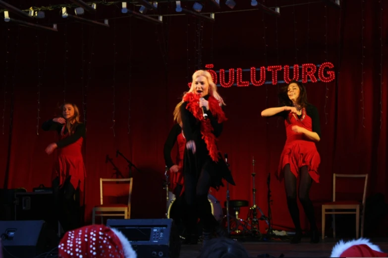 two female entertainers are in the middle of performing