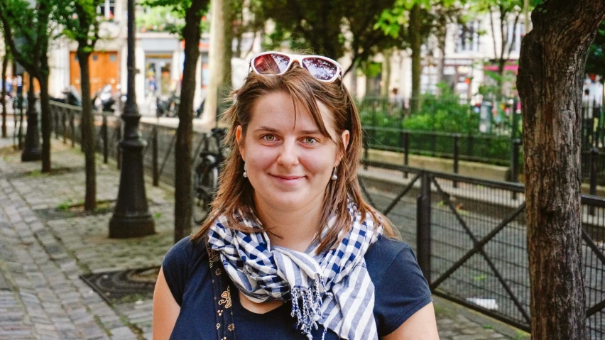 a woman with sunglasses is standing in the street