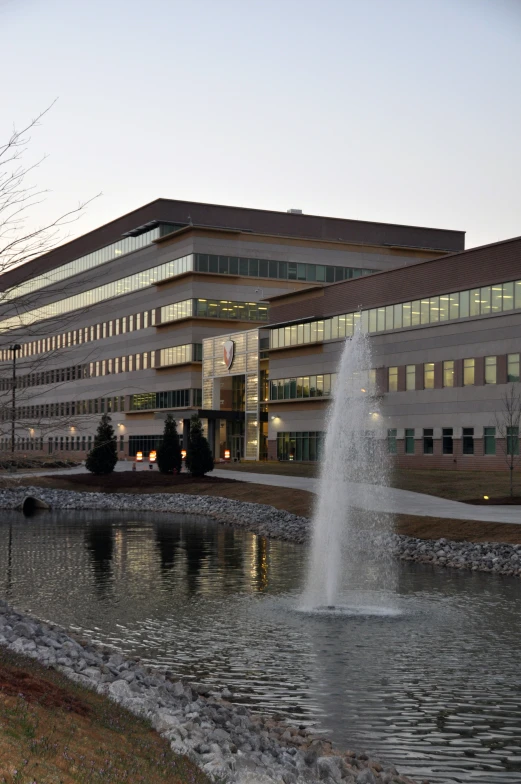 a large building that has a water fountain in front of it