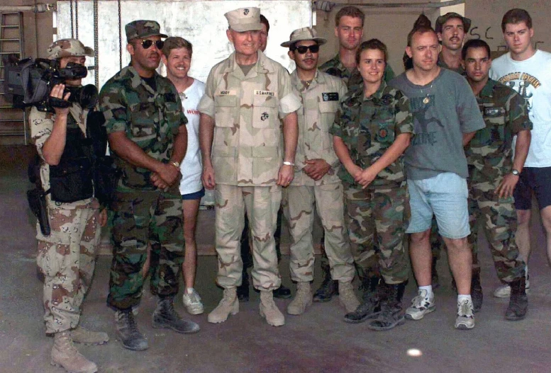 a group of young men wearing army fatigues are posing together for a po